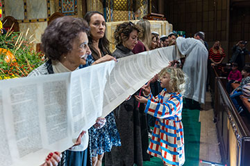 A line of people hold a long scroll of scripture. Links to Gifts of Appreciated Securities A line of people hold a long scroll of scripture. Links to Gifts of Appreciated Securities