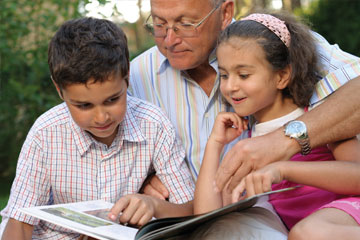 A man reading to his grandchildren. Links to Tangible Personal Property A man reading to his grandchildren. Links to Tangible Personal Property