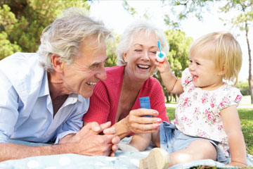 A little girl blowing bubbles with her grandparents. Links to Gifts from Retirement Plans A little girl blowing bubbles with her grandparents. Links to Gifts from Retirement Plans
